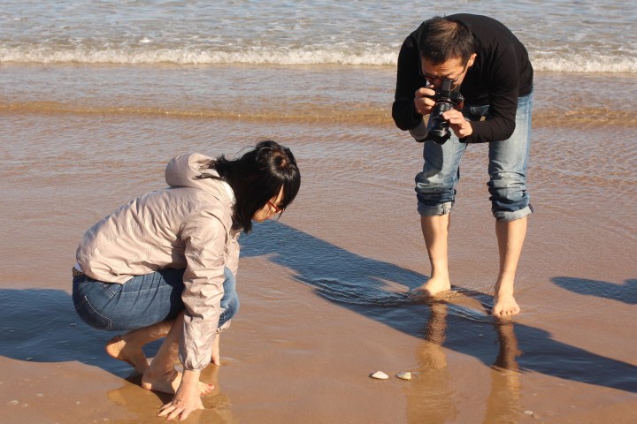 a person standing on a beach near a body of water