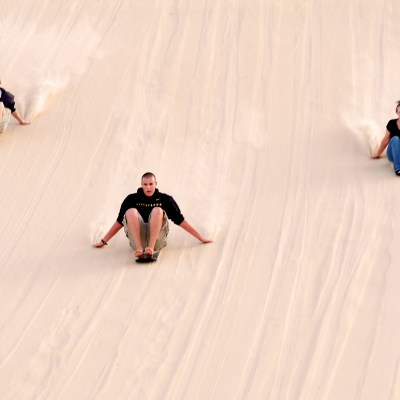 a group of people riding skis down a snow covered slope