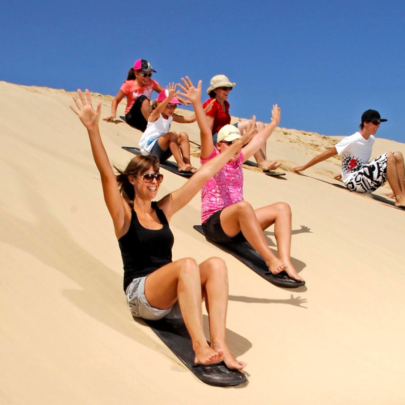 a group of people sitting at a beach