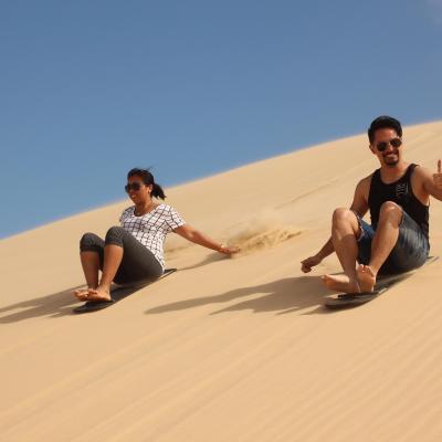 a man riding a snowboard down a snow covered hill