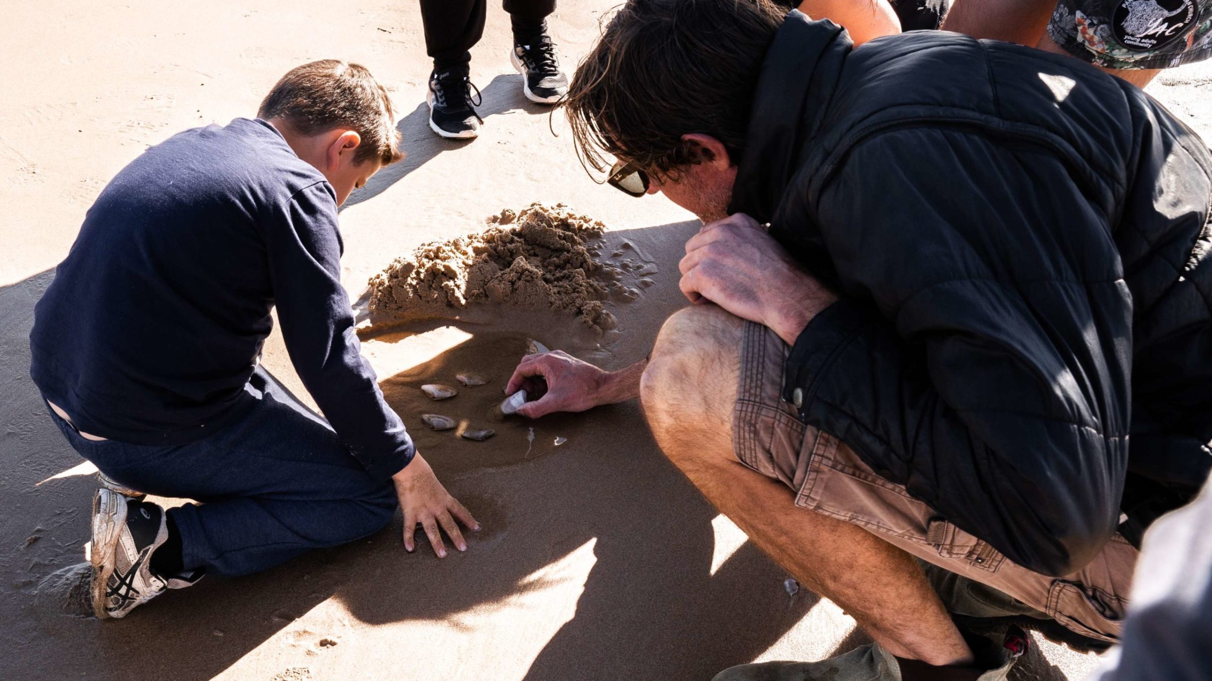 a group of people sitting on the ground