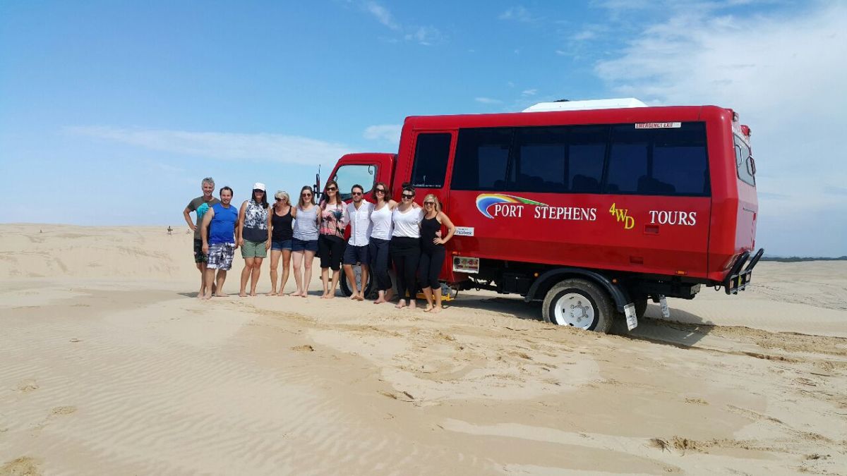 a large red truck on a beach