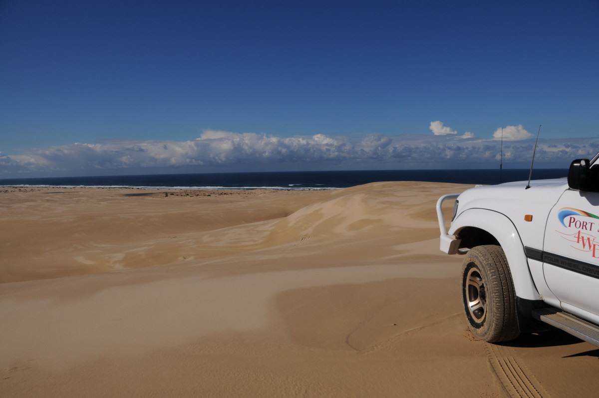 a truck is parked on the beach